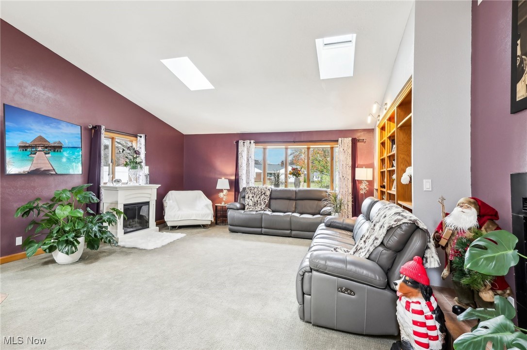 753 Ewing Road Youngstown, OH 44512 - Photo 5 of 47 Living room featuring carpet flooring, plenty of natural light, and lofted ceiling