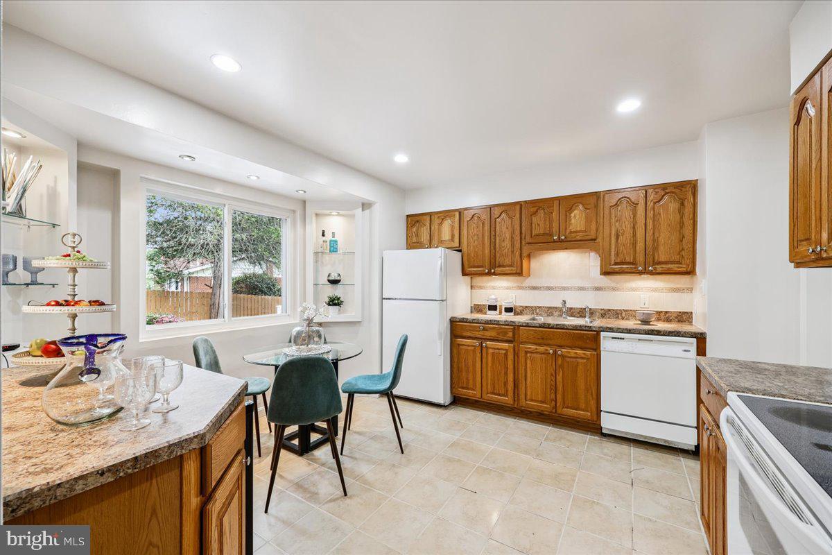 1901 Ladd Street Silver Spring, MD 20902 - Photo 27 of 101 a kitchen with granite countertop cabinets stainless steel appliances a sink and a dining table view
