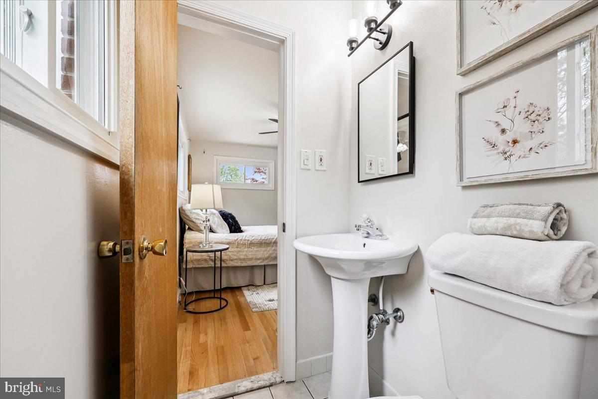 1901 Ladd Street Silver Spring, MD 20902 - Photo 45 of 101 a bathroom with a sink and mirror with bathtub