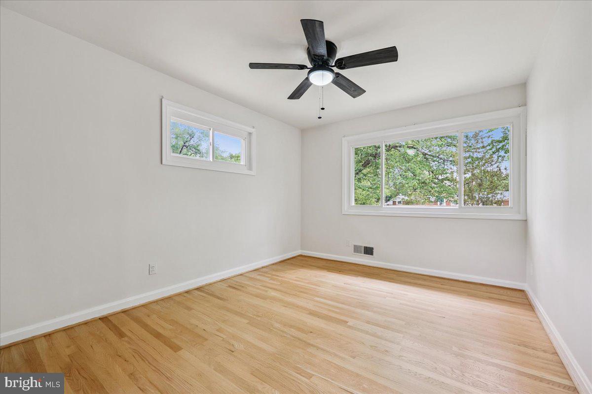 1901 Ladd Street Silver Spring, MD 20902 - Photo 46 of 101 a view of empty room with wooden floor and fan
