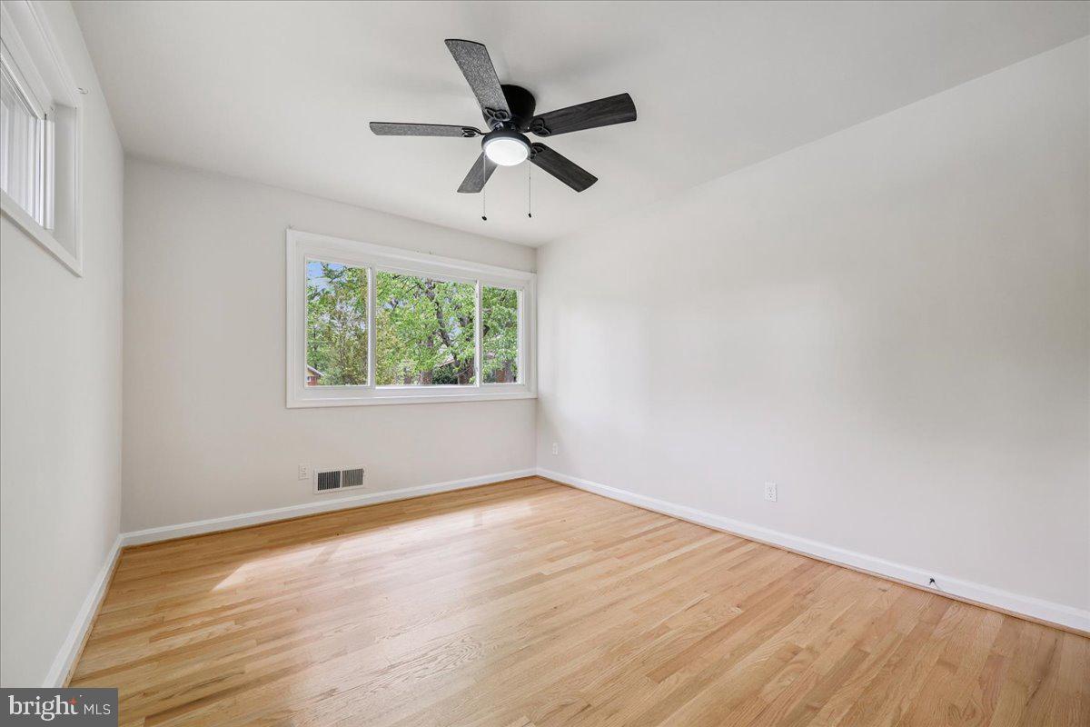 1901 Ladd Street Silver Spring, MD 20902 - Photo 47 of 101 an empty room with wooden floor fan and windows