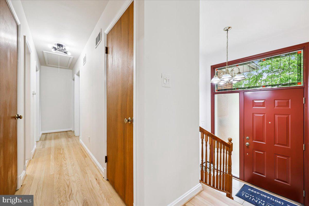1901 Ladd Street Silver Spring, MD 20902 - Photo 56 of 101 a view of a hallway with wooden floor and door