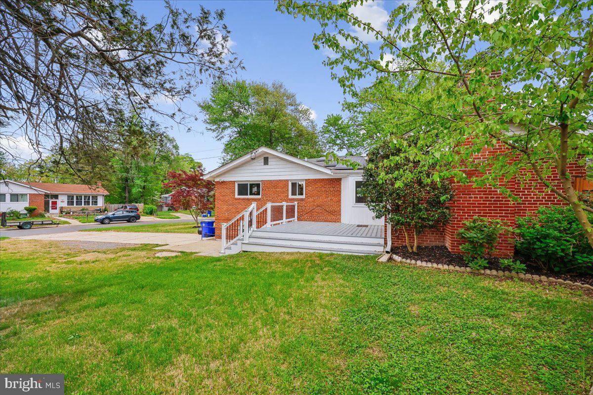 1901 Ladd Street Silver Spring, MD 20902 - Photo 95 of 101 a front view of a house with a garden and trees
