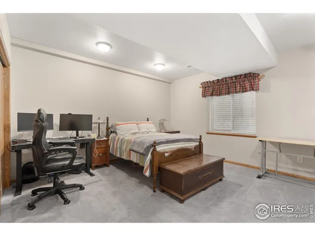 a bedroom with furniture and a air conditioner vent