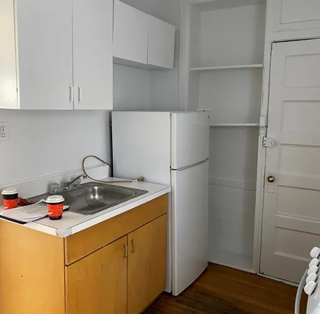 a kitchen with a refrigerator and cabinets
