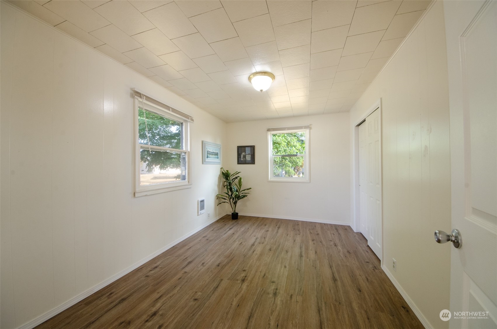 18118 Bend Street Southwest Rochester, WA 98579 - Photo 8 of 13 wooden floor in an empty room with a window