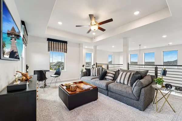 a living room with furniture a rug and a window