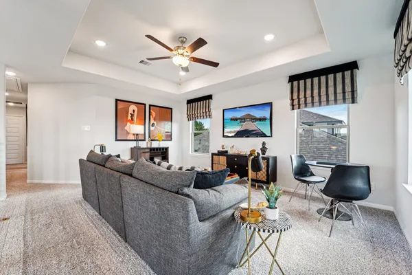 a living room with furniture and a chandelier