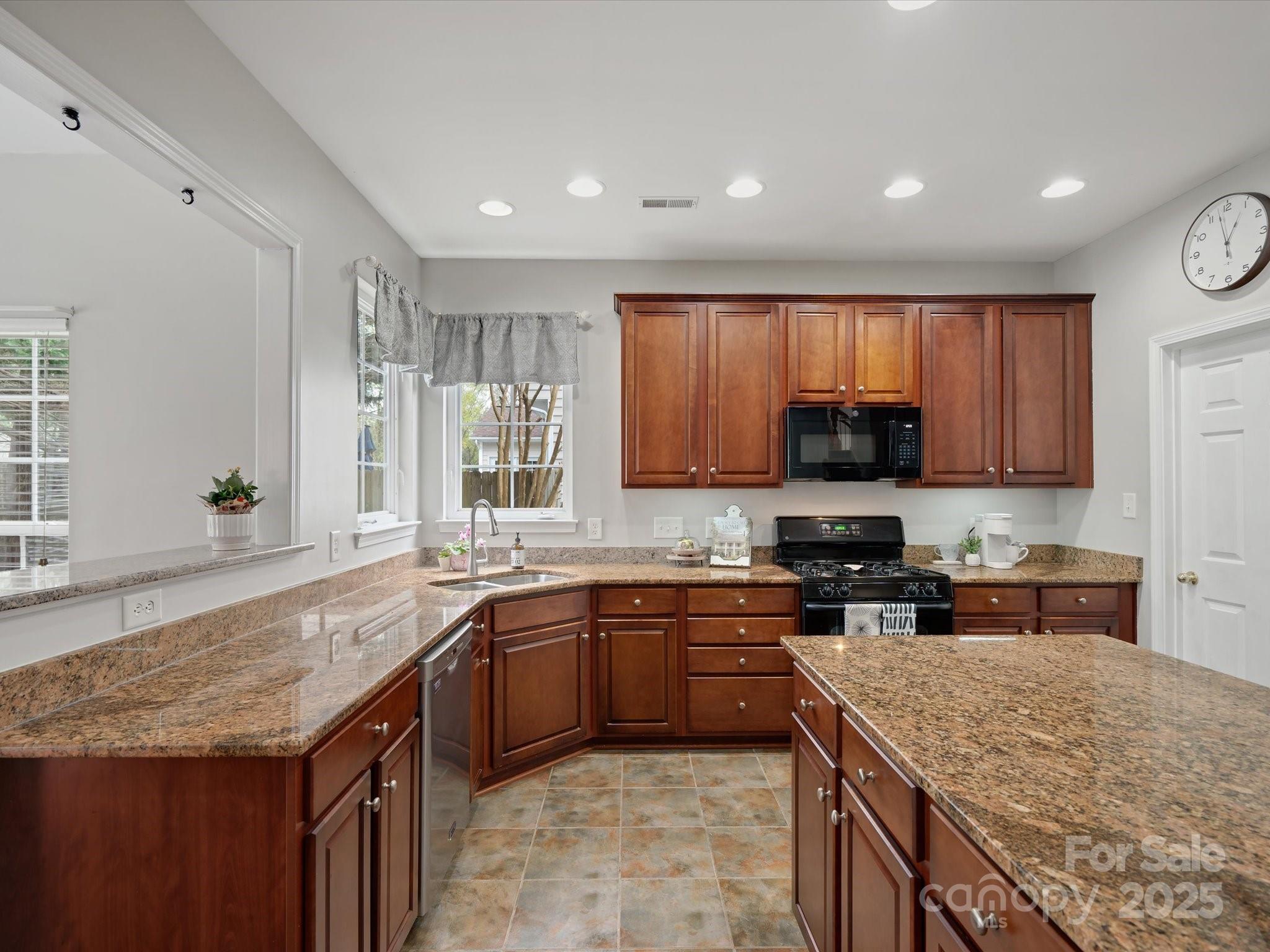 809 Circle Trace Road Monroe, NC 28110 - Photo 23 of 47 a kitchen with a sink stove top oven and cabinets