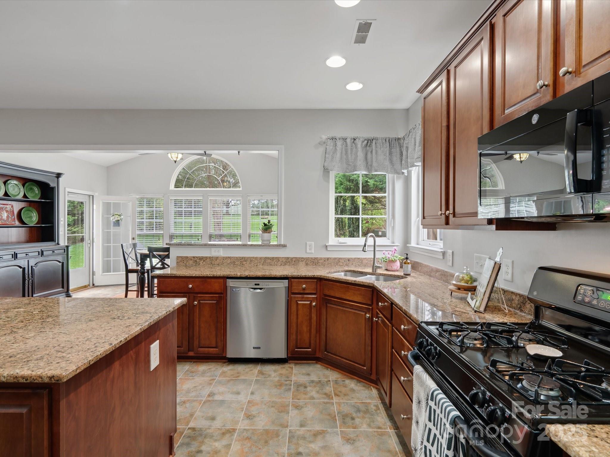 809 Circle Trace Road Monroe, NC 28110 - Photo 24 of 47 a kitchen with stainless steel appliances granite countertop a stove a sink and a microwave