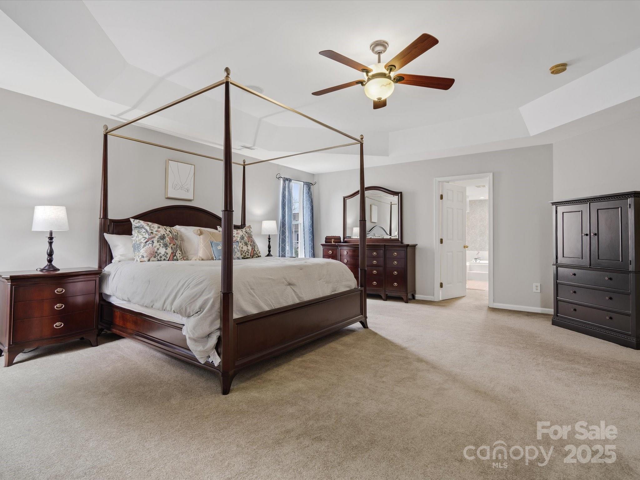 809 Circle Trace Road Monroe, NC 28110 - Photo 29 of 47 a bedroom with a bed chandelier and a window