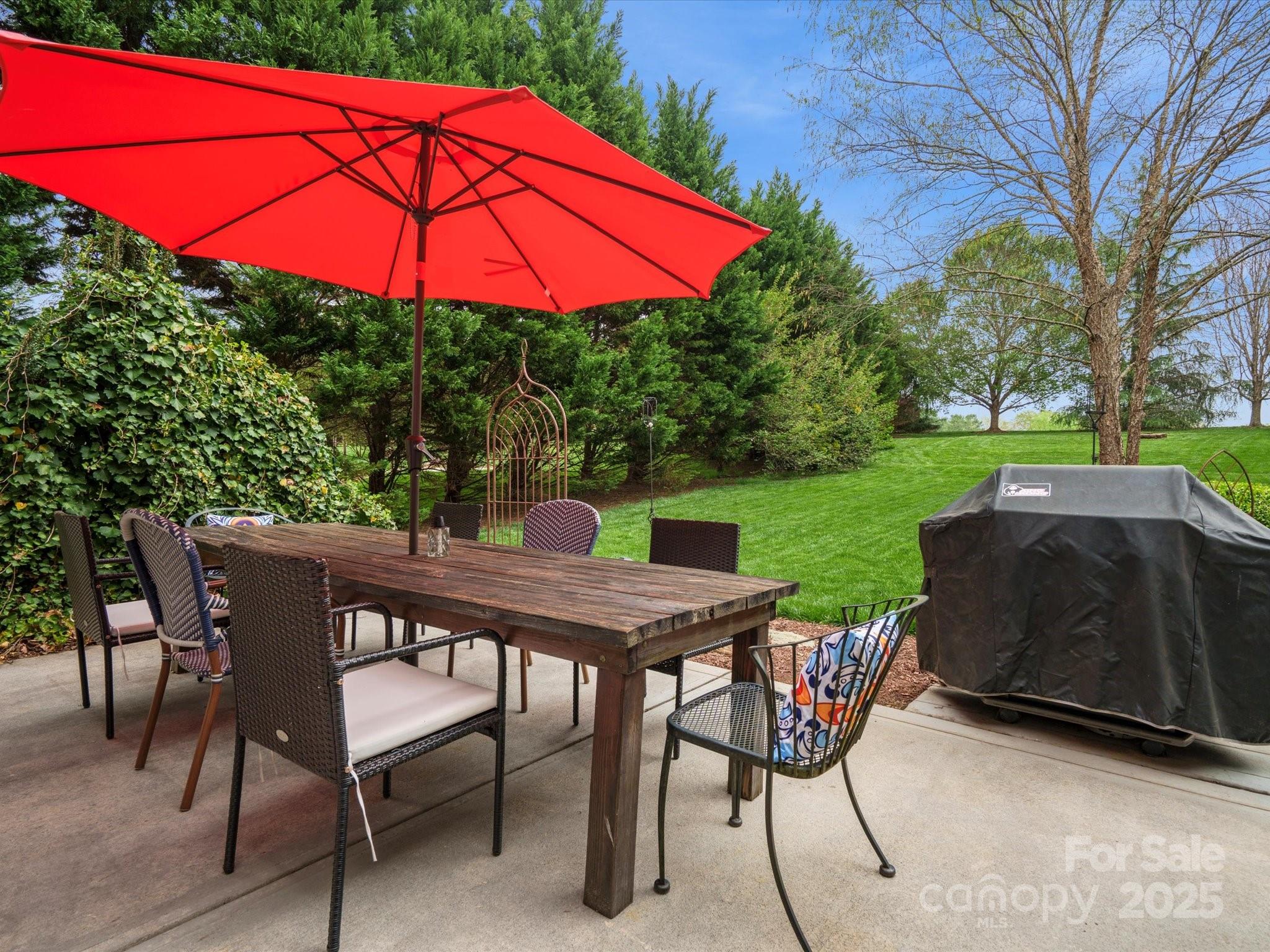 809 Circle Trace Road Monroe, NC 28110 - Photo 40 of 47 a patio with a table and chairs under an umbrella