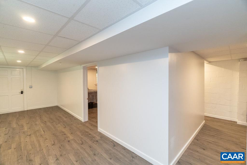 6920 Albevanna Spring Road Scottsville, VA 24590 - Photo 31 of 47 an empty room with wooden floor and windows