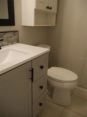 a white toilet sitting next to a bathroom sink