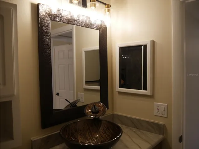a bathroom with a sink and a mirror