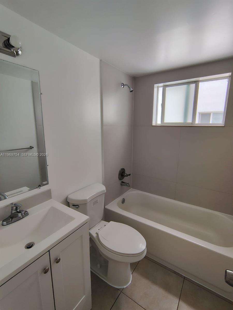741 Northwest 60th Street, Unit 3 Miami, FL 33127 - Photo 11 of 15 a bathroom with a sink a toilet and shower