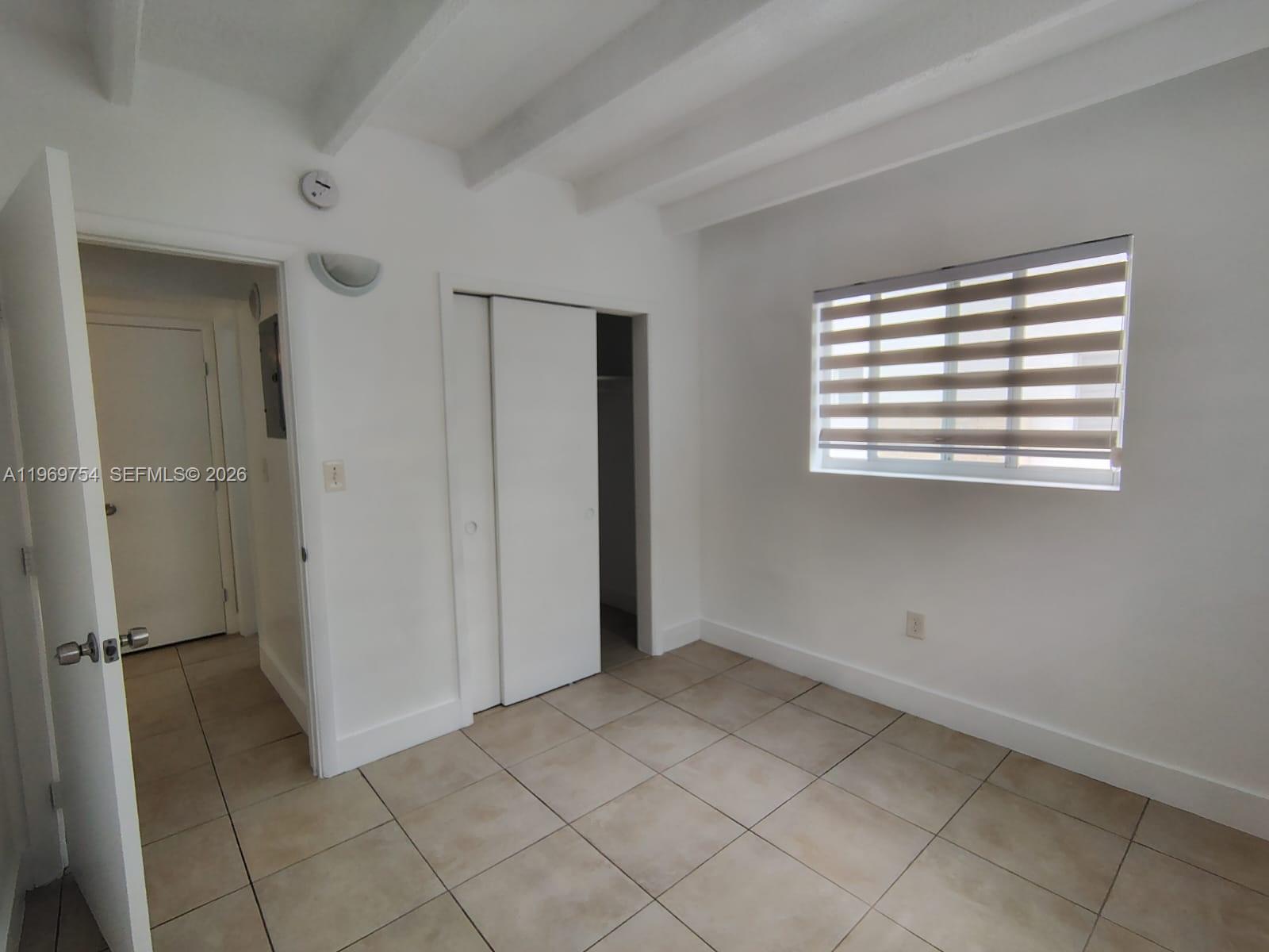741 Northwest 60th Street, Unit 3 Miami, FL 33127 - Photo 12 of 15 a view of an empty room with window and closet area
