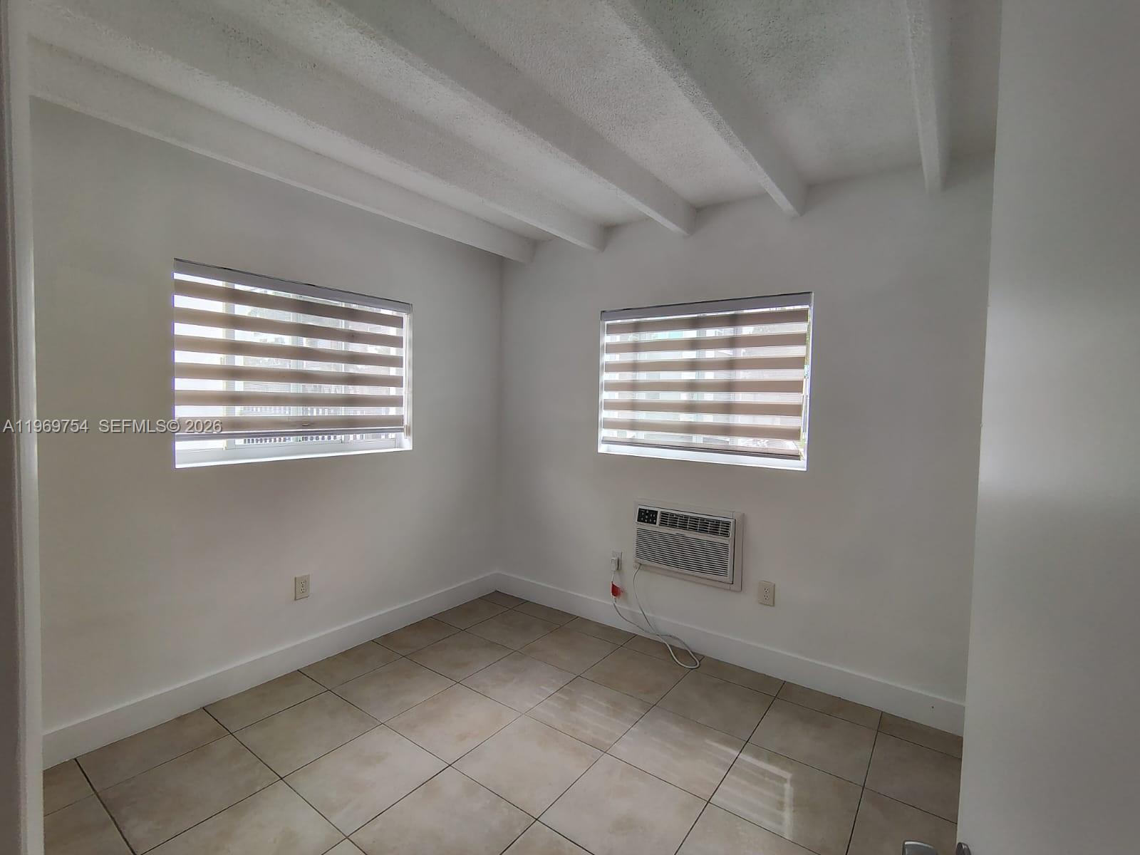 741 Northwest 60th Street, Unit 3 Miami, FL 33127 - Photo 13 of 15 a view of room and window