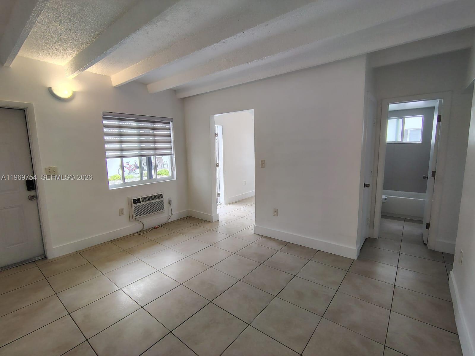 741 Northwest 60th Street, Unit 3 Miami, FL 33127 - Photo 6 of 15 a view of an empty room and a bathroom with a sink