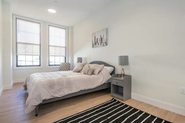 a bedroom with bed and a window