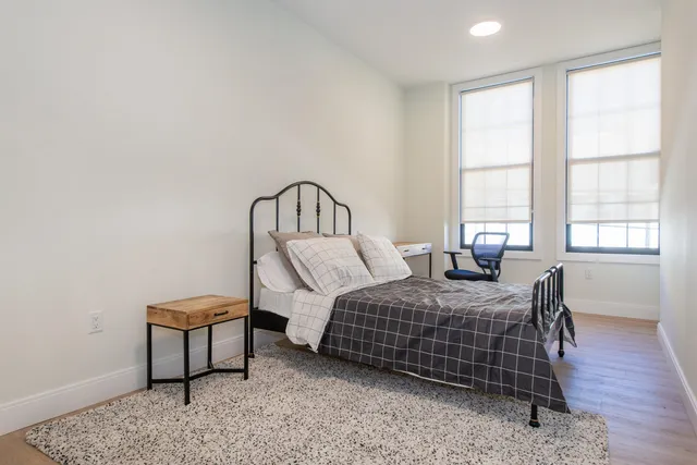 a bathroom with a bathtub shower sink and mirror