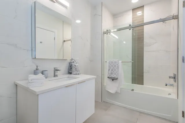 a white toilet sitting next to a bathroom sink