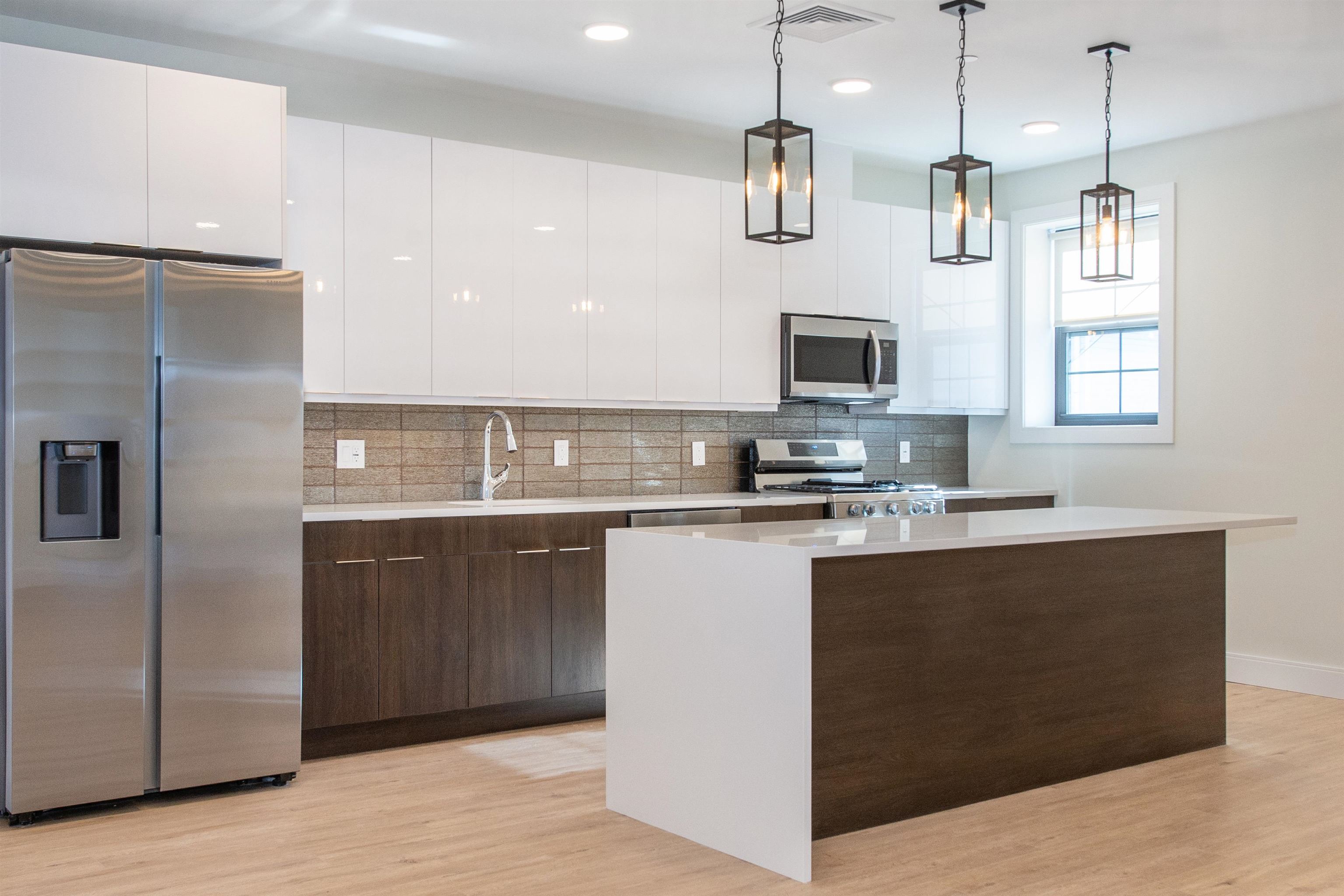 3510 Bergenline Avenue, Unit 205 Union City, NJ 07087 - Photo 4 of 21 a kitchen with stainless steel appliances granite countertop a refrigerator a sink a stove and a microwave