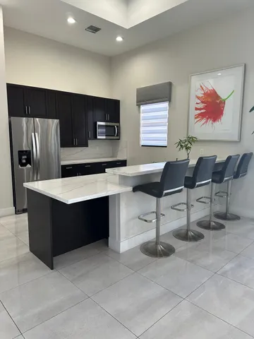 a lobby with furniture and wall paintings