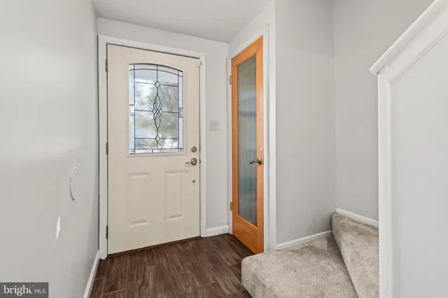 a view of room with window and wooden floor