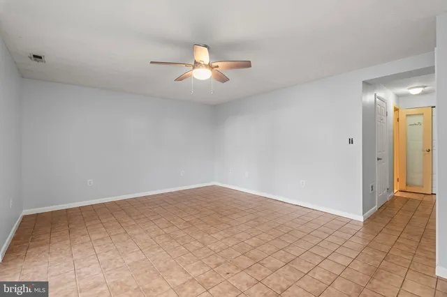 an empty room with kitchen view