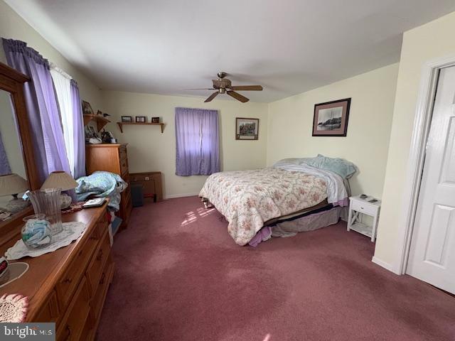 4928 Bethlehem Road Preston, MD 21655 - Photo 7 of 19 a spacious bedroom with a bed and a chandelier