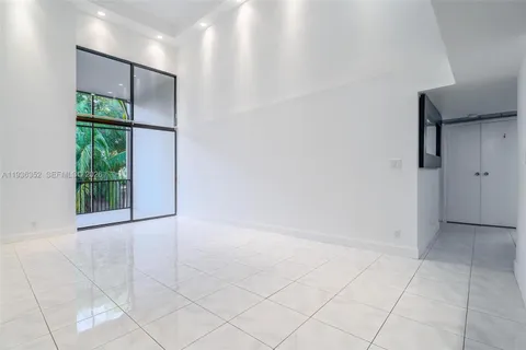 a living room with furniture ceiling fan and a table
