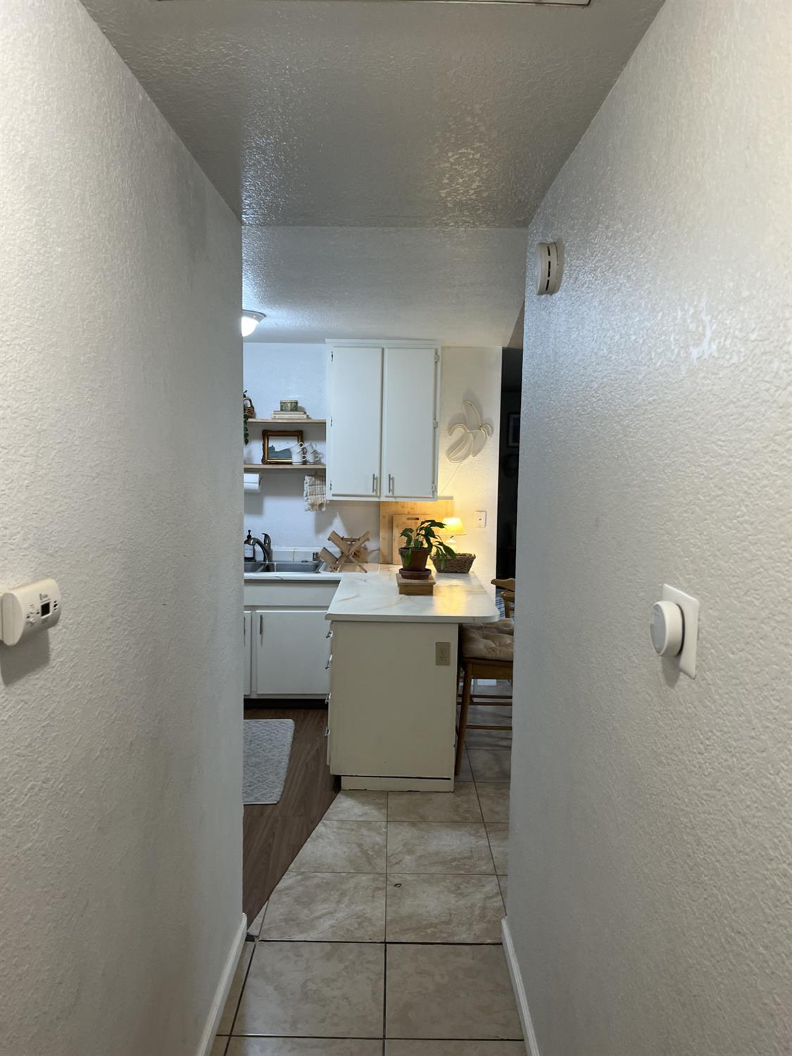 113 Atkinson Street Roseville, CA 95678 - Photo 20 of 22 a kitchen with a sink and white cabinets