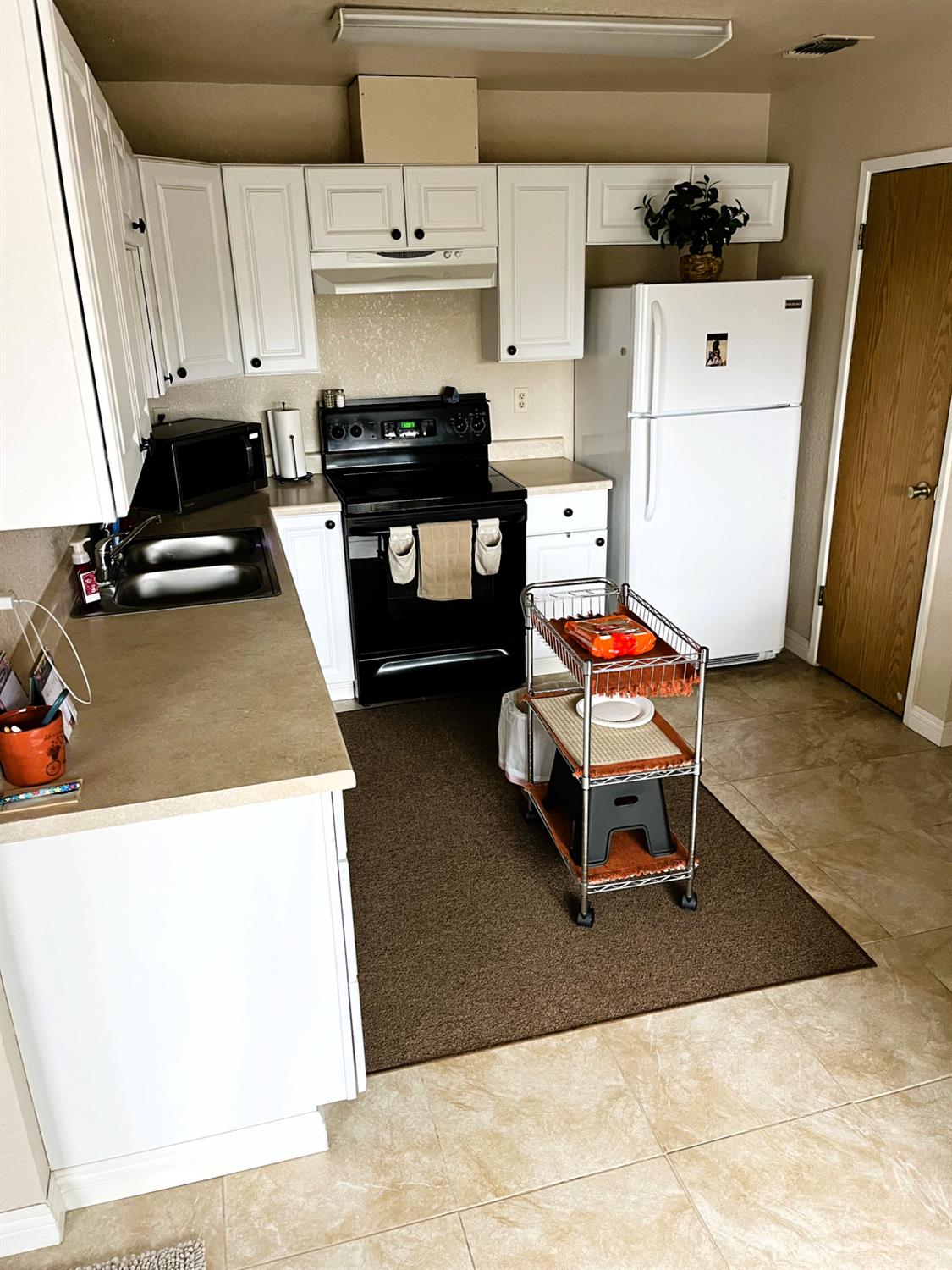 113 Atkinson Street Roseville, CA 95678 - Photo 10 of 22 a kitchen with stainless steel appliances a stove a refrigerator and a sink