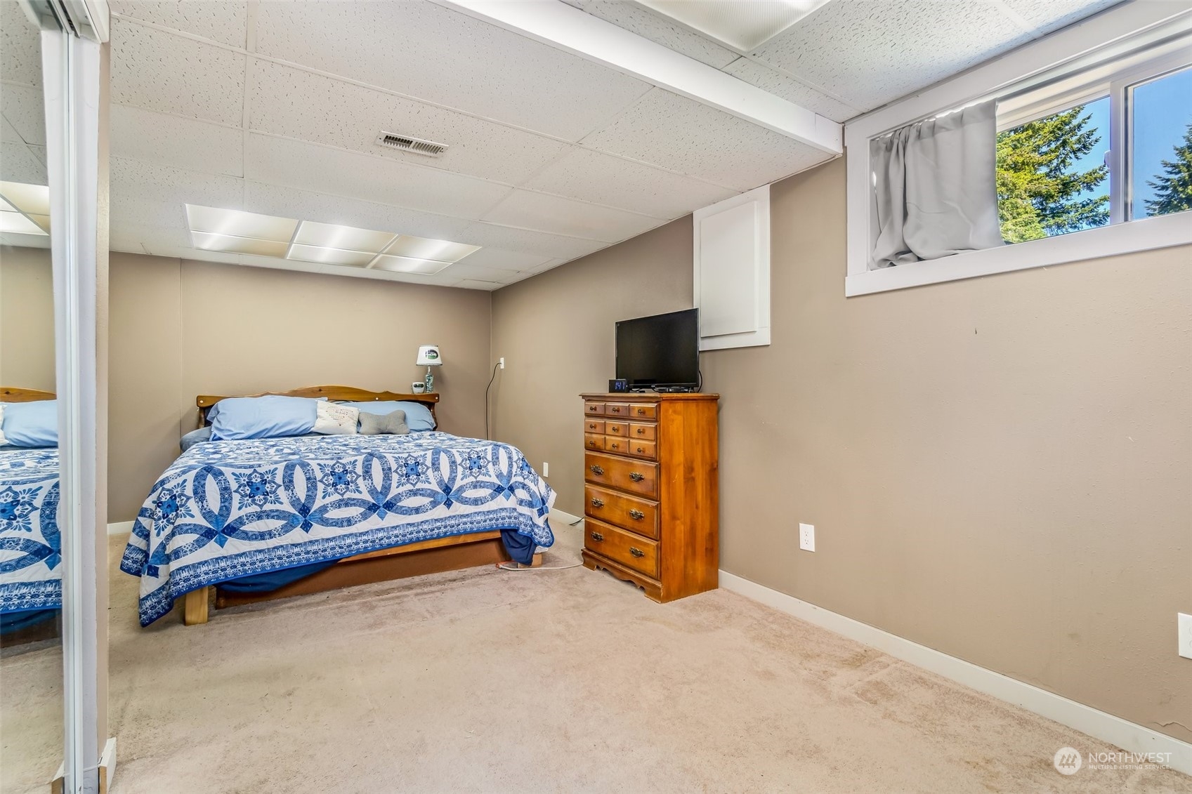 612 219th Place Southwest Bothell, WA 98021 - Photo 18 of 32 a bedroom with a bed and flat tv screen on the wall