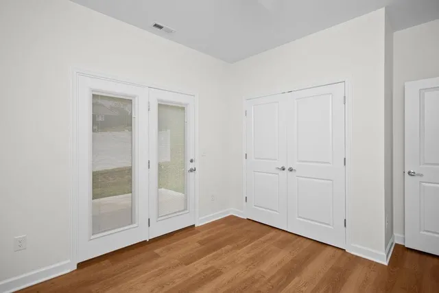 a view of empty room with wooden floor