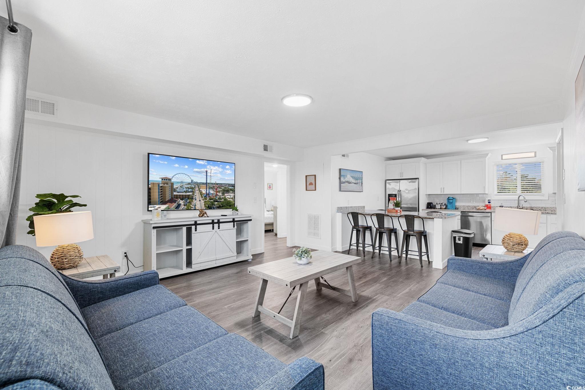 409 17th Avenue North, Unit 3 Myrtle Beach, SC 29577 - Photo 11 of 16 Living room featuring dark wood-style floors