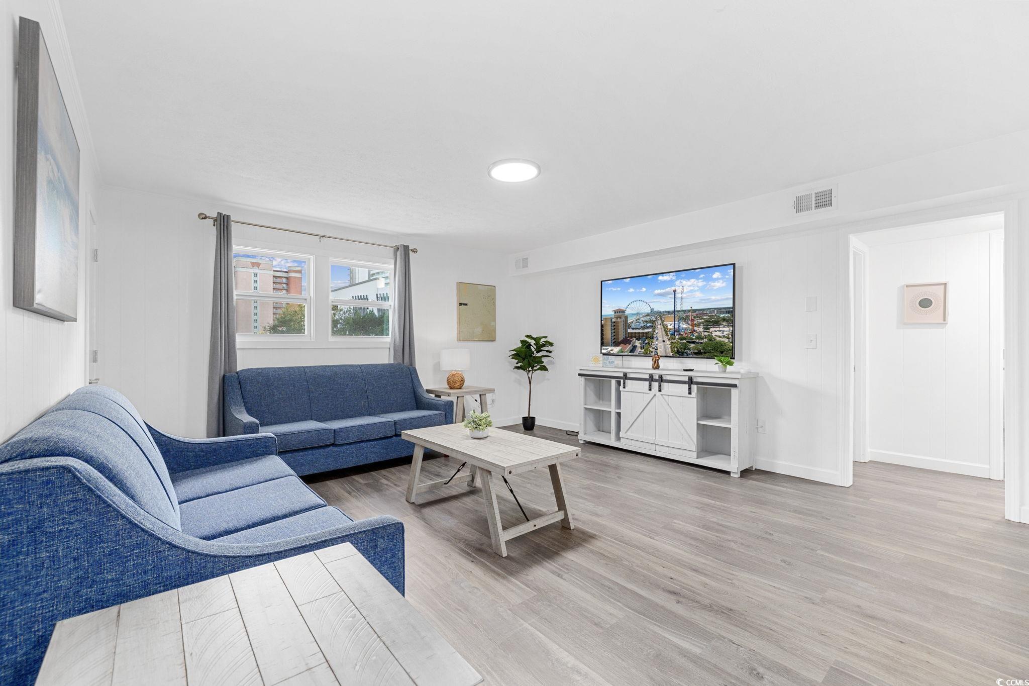 409 17th Avenue North, Unit 3 Myrtle Beach, SC 29577 - Photo 12 of 16 Living area with light wood-type flooring and baseboards