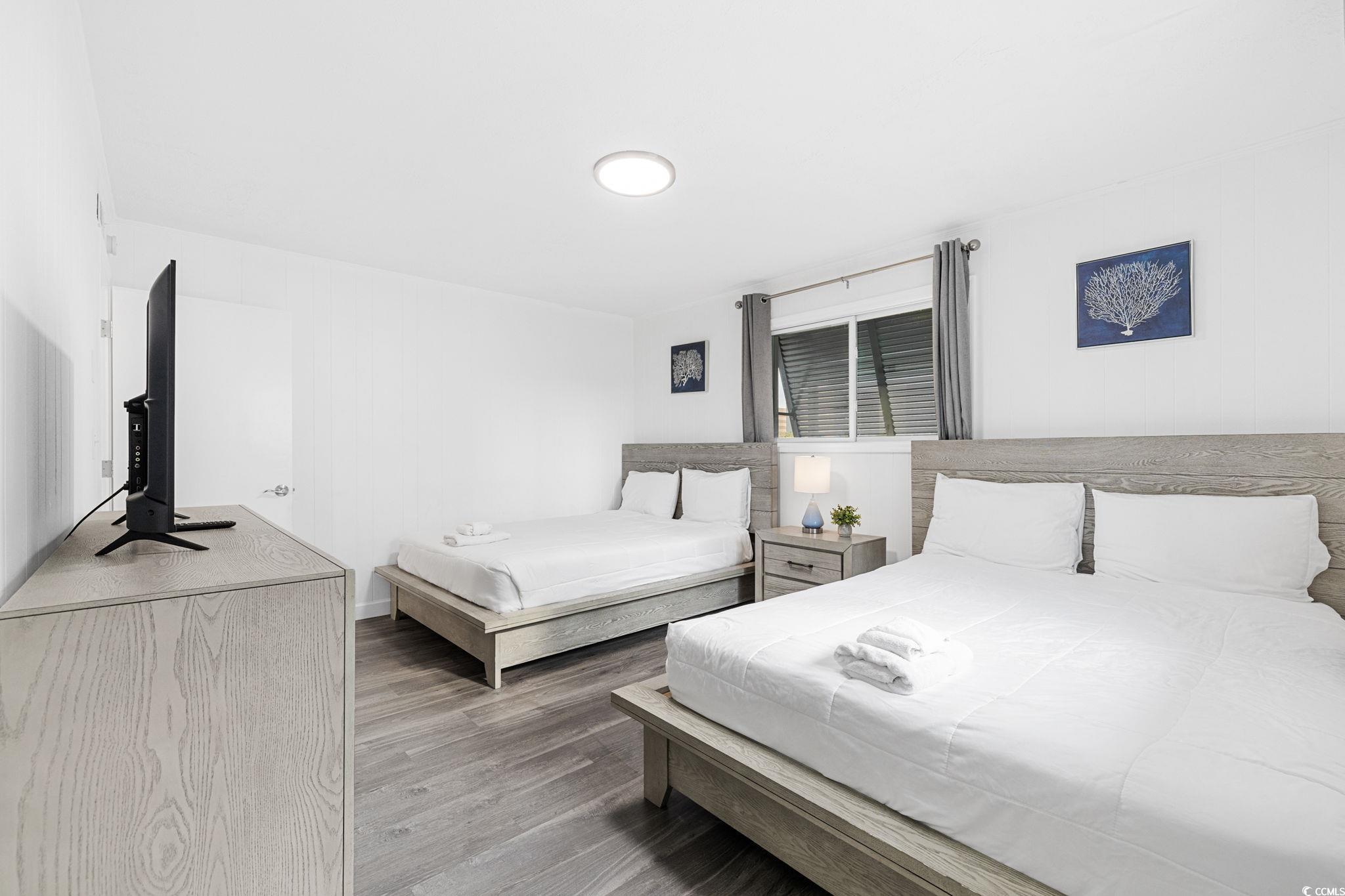 409 17th Avenue North, Unit 3 Myrtle Beach, SC 29577 - Photo 14 of 16 Bedroom featuring wood finished floors and baseboards