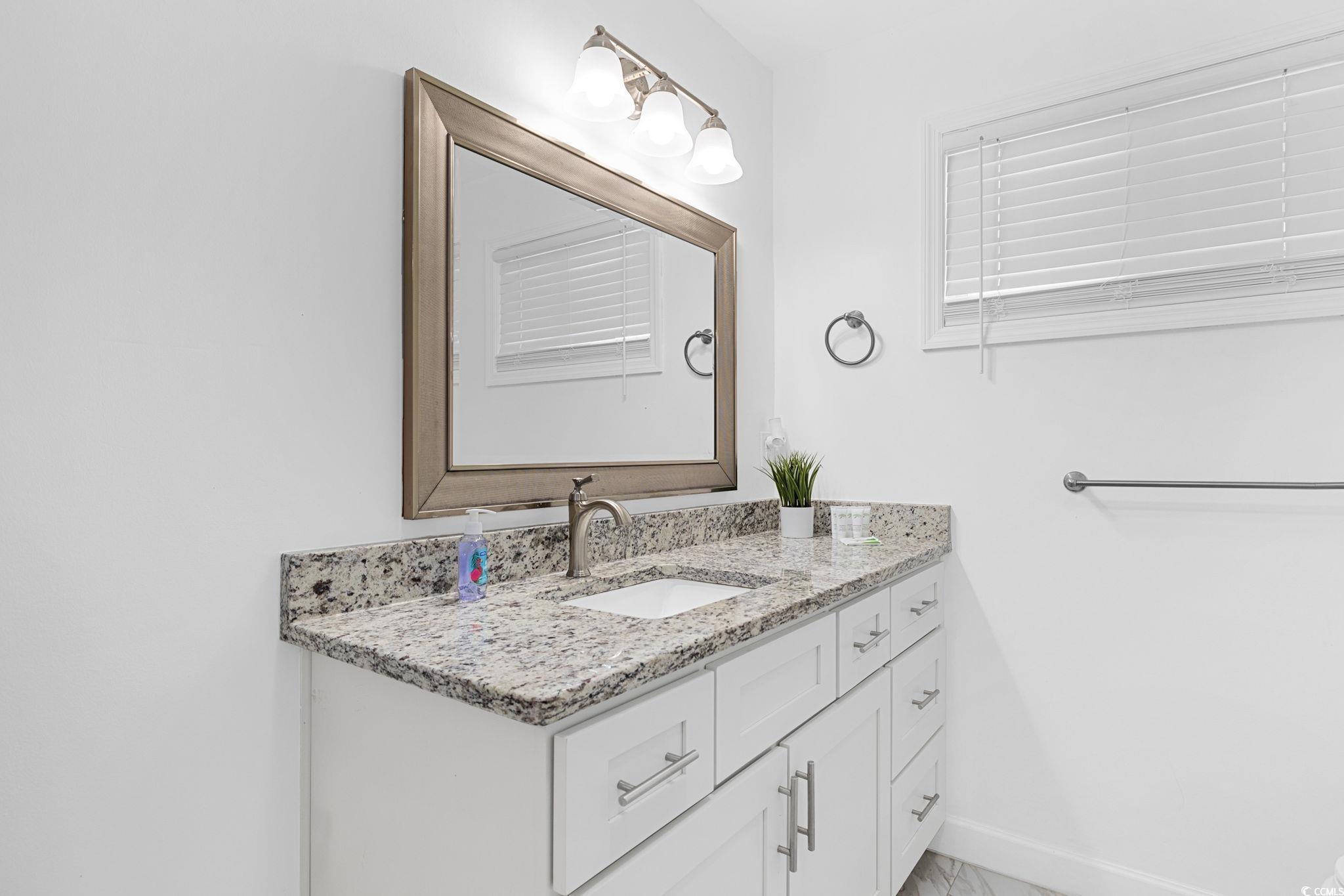 409 17th Avenue North, Unit 3 Myrtle Beach, SC 29577 - Photo 15 of 16 Bathroom with vanity and baseboards