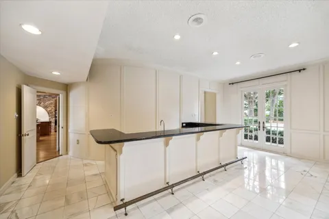 a living room with furniture kitchen and a large window