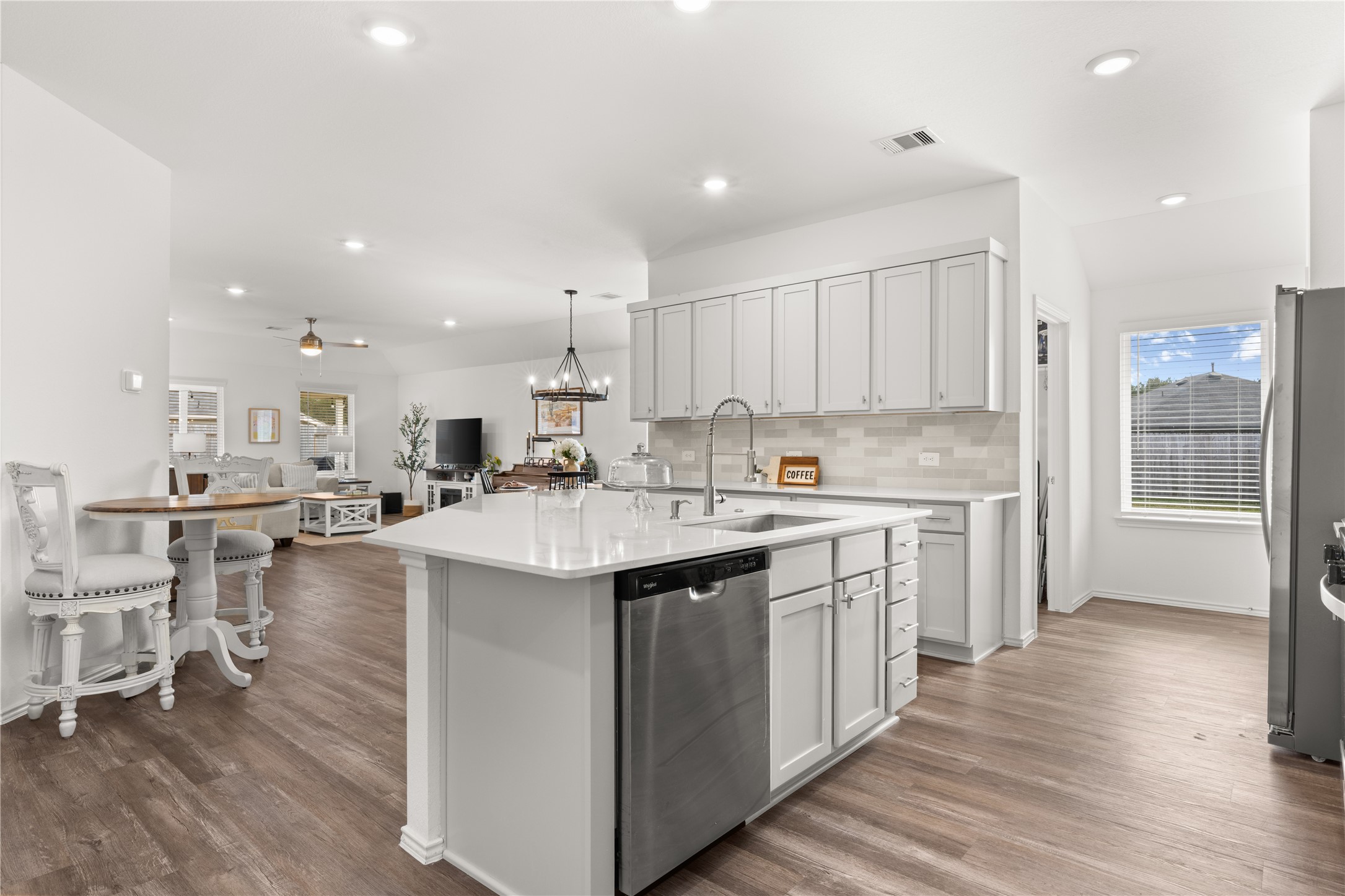 18771 Goldbach Road New Caney, TX 77357 - Photo 5 of 38 This spacious kitchen features a stunning quartz island w/ ample storage and open to the dining and living area for effortless entertaining.