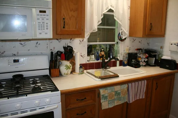 a kitchen with wooden cabinets and a stove top oven