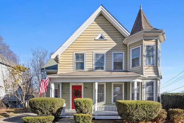 a view of a brick house with potted plants