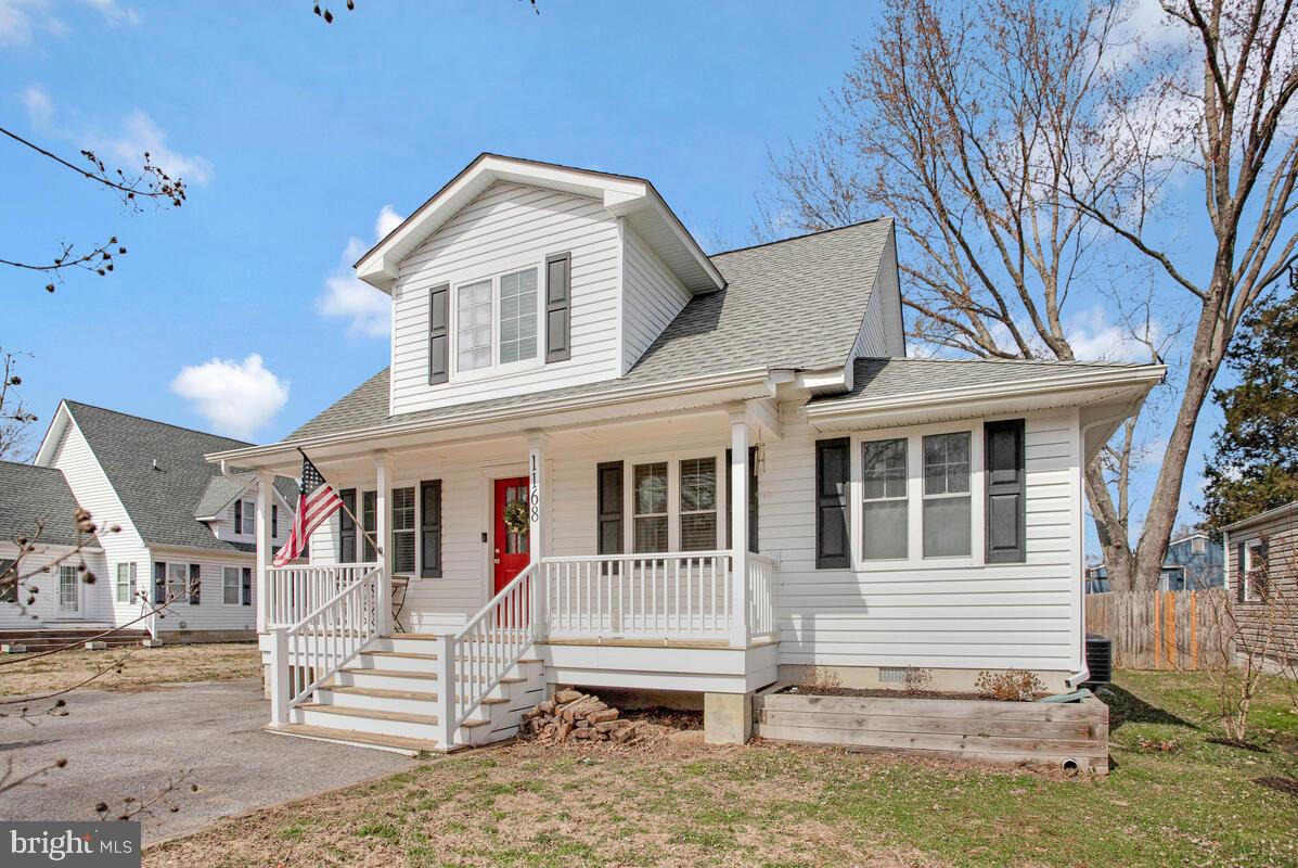 Charming home with inviting porch and flag.