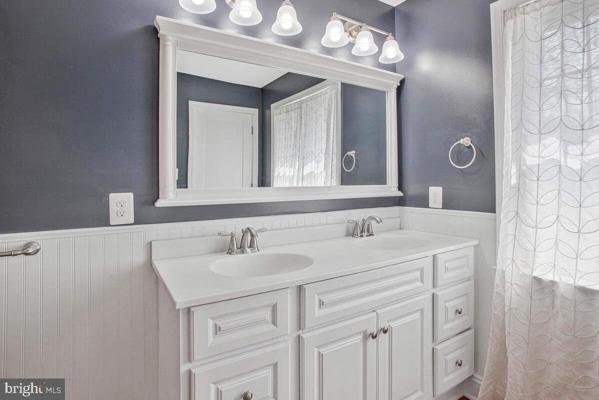 1168 Maple Avenue Shady Side, MD 20764 - Photo 21 of 52 Elegant dual-sink bathroom with modern charm.
