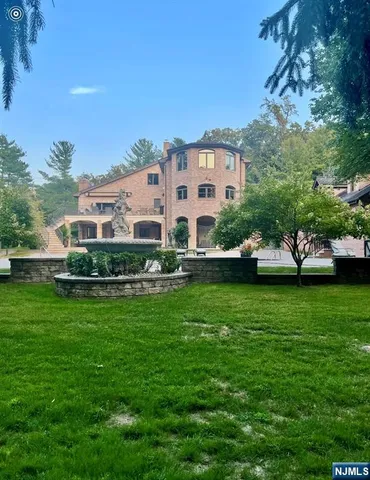a front view of a house with a yard table and chairs