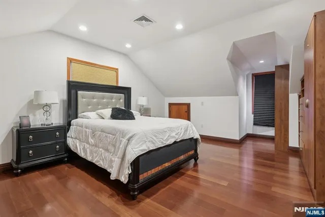 a bedroom with a bed and a night stand