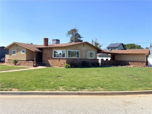 a front view of a house with a garden and deck