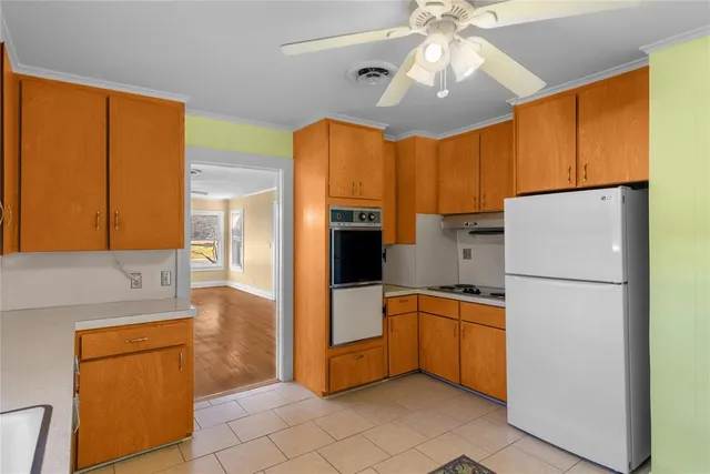 a kitchen with stainless steel appliances granite countertop a refrigerator a sink and dishwasher